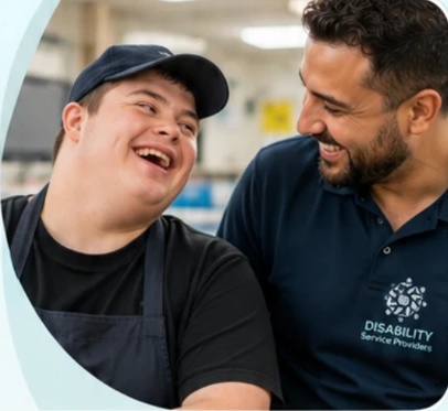 A participant and a support worker sharing a smile